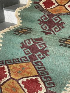 an area rug on the ground with stairs in the background and steps leading up to it