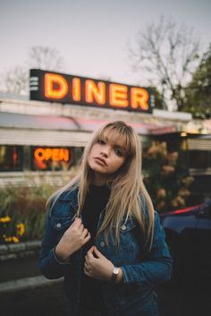 a woman standing in front of a diner