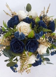 a bouquet of blue and white flowers with greenery