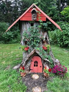 a tree stump house with plants growing out of it