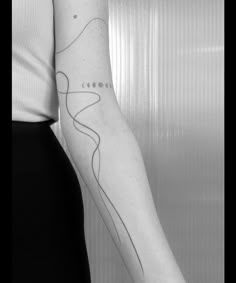 a black and white photo of a woman's arm with a line drawing on it