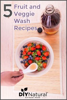 a bowl of fruit and veggie wash recipes on a table with a spoon