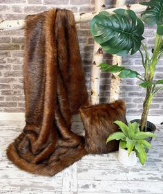 The Reynard faux fur throw is a new design to our collection. It is a thick faux fur the quality of which would be difficult to find anywhere on the high street. It has a rich reddish brown dense undercoat, which is complimented with longer mid-dark brown hairs on the surface. As with all of the fur throws we produce, it is available in 9 standard sizes. This fur is quite heavy in the larger fur throw sizes. And of course, if you still can't find the size that you want please give us a call and Cozy Brown Fur Coat With Faux Fur Lining, Brown Cozy Fur Coat With Faux Fur Lining, Fake Fur Blanket, Brown Hairs, King Size Blanket, Blanket For Bed, Fur Blanket, Fur Throw, Fake Fur