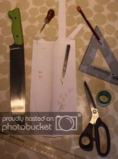 scissors, rulers and other crafting supplies laid out on top of a sheet of paper