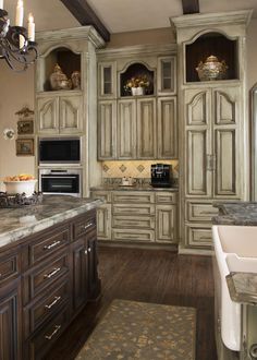 a large kitchen with wooden cabinets and marble counter tops