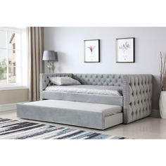 a day bed with pull out trundle and storage underneath the mattress, in a living room