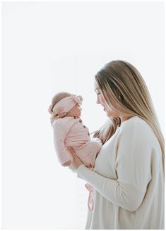 a woman holding a baby in her arms