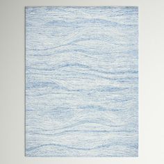 a white and blue rug with waves on it