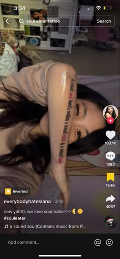 the woman is laying down with her arm tattooed