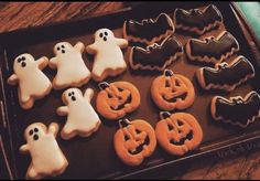 decorated cookies in the shape of ghost and pumpkins