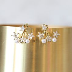 It's a party every time you put our Celebration Studs on! These super fun and sparkly earrings will make a statement and can easily dress up any outfit! *Earrings have Cubic Zirconia stars and Pearls The star stud connects to the fan portion of the earring behind your ear to curve below your earlobe. Elegant Star-shaped Crystal Earrings For Party, Gold Star-shaped Crystal Earrings For Party, Sparkling Star Crystal Earrings For Party, Sparkling Star-shaped Crystal Earrings For Party, Star-shaped Crystal Earrings For Party, Sparkly Earrings, Bead Store, Star Studs, The Star