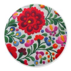 a white round with colorful flowers on it