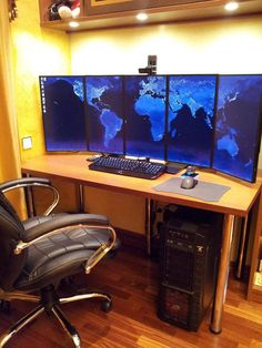 a chair sitting in front of a computer desk with three monitors on top of it