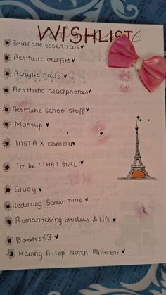 a wish list with the eiffel tower in pink and orange on it's side