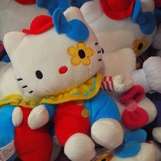 many hello kitty stuffed animals are stacked together