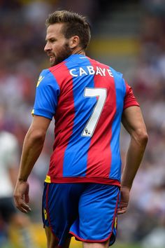 a soccer player is standing on the field