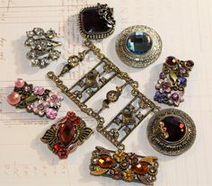 an assortment of brooches sitting on top of a piece of paper