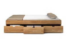 a bed with two drawers underneath it and a white sheet on the bottom shelf next to it