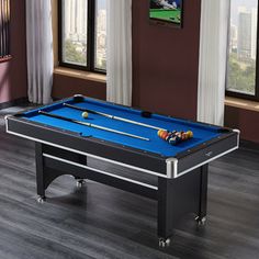 a blue pool table in a living room