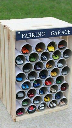 a wooden box filled with lots of different types of cars on top of cement ground