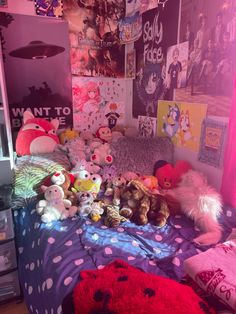 a bed with lots of stuffed animals on it in a room filled with posters and pictures