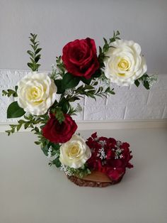 three white and red roses in a vase