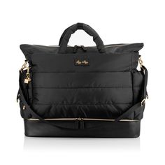 a black handbag with gold handles and zippers on the front, sitting on a white