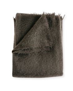 a brown blanket folded on top of a white surface with a black border around it