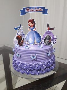 there is a purple cake with princesses on it