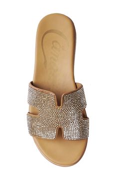 Side cutouts and sparkling embellishments add statement-making appeal to a slide sandal that will complement your weekend-ready looks. 1" heel Leather upper and lining/synthetic sole Imported Chic Rhinestone Open Toe Mules, Rhinestone Embellished Open Toe Mules, Rhinestone Open Toe Mules, Embellished Open Toe Mules For Summer, Gold Leather Sandals With Rhinestones, Leather Sandals With Rhinestones For Beach, Nordstrom Store, Sandal Women, Anniversary Sale