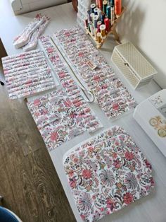 sewing supplies laid out on a table in front of a sewing machine and other crafting supplies