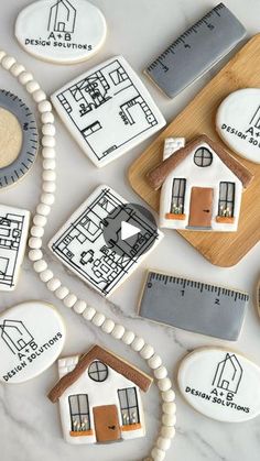 some cookies are arranged on a table with rulers and other items to make them look like houses