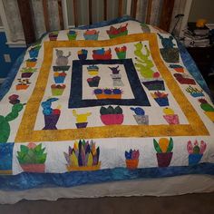 a quilted bedspread with cactus designs on it