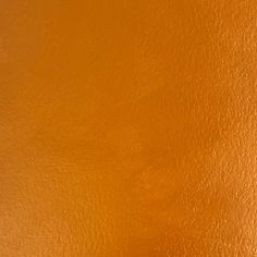 an orange leather background with some stains on it