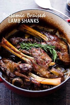 lamb shans in a pot with rosemary garnish on top and text overlay