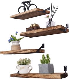 three wooden shelves with plants and vases on them