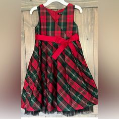 Absolutely Gorgeous Plaid Taffeta Christmas Holiday Dress By George. Girl's Size 8, Sleeveless With Crossover-Look Bodice. Full Gathered Skirt With Tulle Ruffled Underskirt For Added Fullness. Wide Red Grosgrain Ribbon Sash (Removable) Ties In Bow At Waist. Zipper Close Back. New And Never Worn. Received As A Gift And Was Tucked Away In A Closet And Unfortunately Was Outgrown Before It Was Able To Be Worn. Armpit To Armpit Measures 14.5 Inches. Top Of Shoulder To Bottom Hem Of Skirt 30 Inches. F Festive Sleeveless Dress For Dress-up, Festive Sleeveless Dress-up Dresses, Sleeveless Dress For Festive Dress-up, Sleeveless Festive Christmas Dress, Festive Sleeveless Christmas Dress, Red Sleeveless Holiday Dress, Red Sleeveless Christmas Holiday Dress, Festive Sleeveless Holiday Dress For Winter, Festive Sleeveless Winter Dress