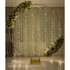 a circular display with flowers and lights in the background is surrounded by curtained drapes