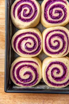 rolls in a baking pan with purple swirls on top