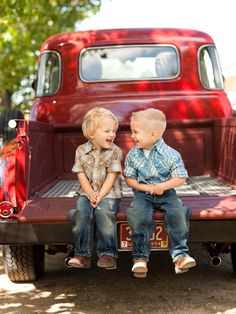 two young boys sitting on the back of a red truck with text that reads, he said he was country then he was like what's mudding?