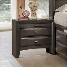 a night stand with three drawers and a clock on top