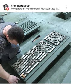 a man is working on some metal designs