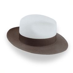 Description Materials Craftsmanship Hat Care Shipping Returns Product Description Elegant Two-Tone Panama Fedora: Where Straw Meets Felt Introducing the Monarch, a unique two-tone Panama fedora that blends the best of both worlds. This distinctive hat features a breathable Toquilla straw crown in off-white, beautifully contrasted with a taupe brown rabbit fur felt brim. The Monarch boasts a classic center-dent crown standing 5" tall and a generous 3" raw-edge snap brim, creating a silhouette tha Homburg Hat, Hats For Big Heads, Brown Rabbit, Homburg, The Monarch, Crown Design, Formal Casual, Head Shapes, Hat Band