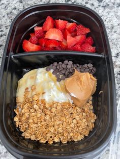 a plastic container filled with oats, strawberries and peanut butter on top of it