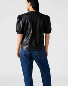 The JANE top boasts a contemporary design with a touch of femininity. Its soft faux leather fabric provides structure to the short puff sleeve pullover style. The split V-neck collar and half-length puff shoulder complete its sleek and polished look. V-neck faux leather top Unlined with soft inner facing Length: 23.5" 100% polyurethane Care instructions: wipe clean with a damp cloth, do not bleach, line dry, use pressing cloth and iron on low if necessary, do not dry clean Shop the set here Mari Fitted Faux Leather Tops For Work, Fitted Faux Leather Top For Work, Modern Puff Sleeve Blouse For Fall, Modern Puff Sleeve Top For Work, Chic Tops With Padded Shoulders For Fall, Padded Shoulder Tops For Workwear In Fall, Trendy Leather Tops For Spring, Fall Tops With Structured Shoulders And Puff Sleeves, Faux Leather Tops For Spring Workwear