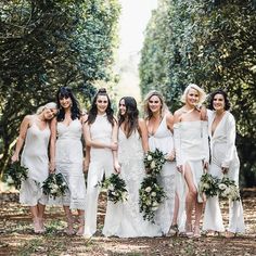 a group of women in white dresses standing next to each other