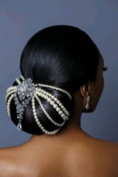 the back of a woman's head with pearls and crystal hair clips in her hair