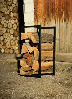 a stack of firewood sitting in front of a building