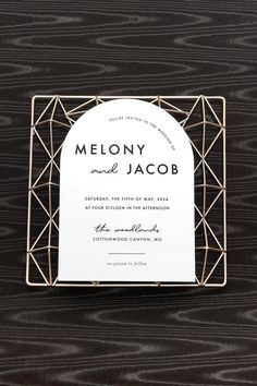 a white and black wedding card with the word melony on it's front