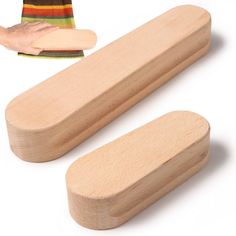 two wooden objects are shown with one being held by a hand